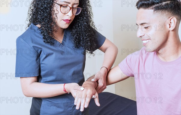 Physiotherapist with patient wrist assessment