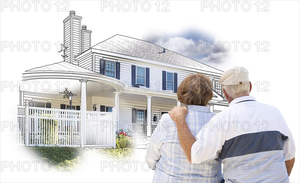 Curious embracing senior couple looking at house drawing and photo combination on white