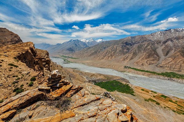 View of Spiti valley in Himalayas with stone cairn