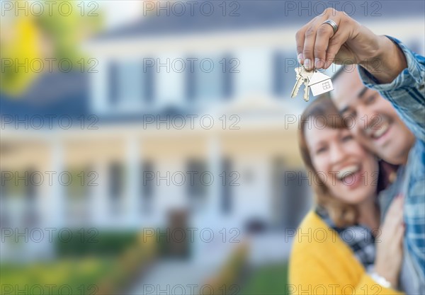 mixed-race couple in front of house with keys