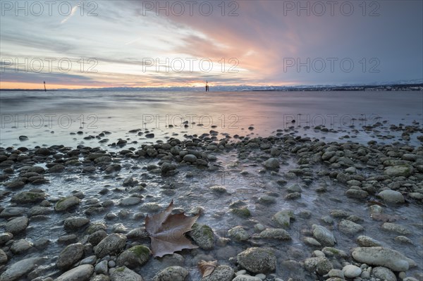 Sunrise on a wintry lake in bad weather