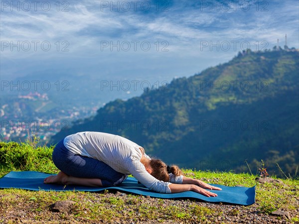 Sporty fit woman practices yoga asana Balasana