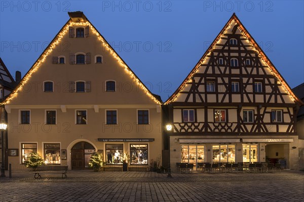 Historic gabled houses with Christmas lighting on the market square in the evening