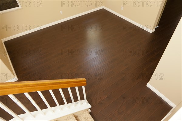 Beautiful newly installed brown laminate flooring and baseboards in home