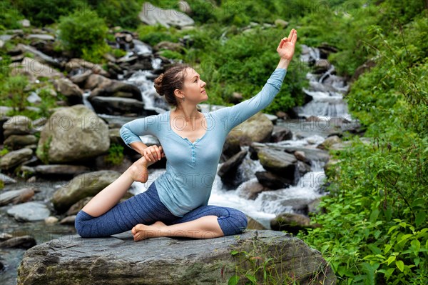 Young sporty fit woman doing yoga asana Eka pada rajakapotasana