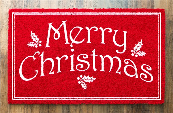 Merry christmas red welcome mat on wood floor background