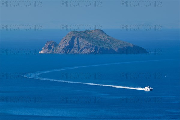 Speeding speed boat catamaran ferry vessel in Aegean sea near Milos island on summer day in Greece