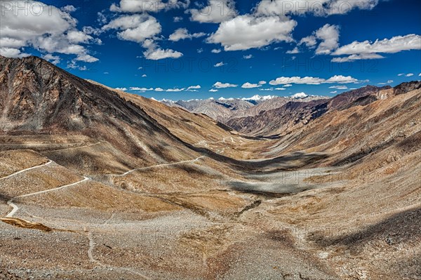 View of Karakoram range and road in valley from Kardung La