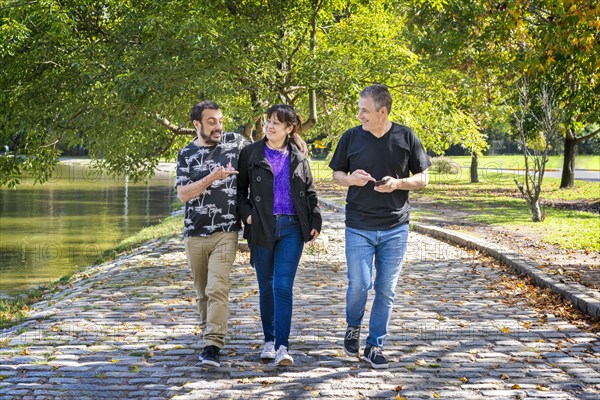 Group of friends walking in a park chatting