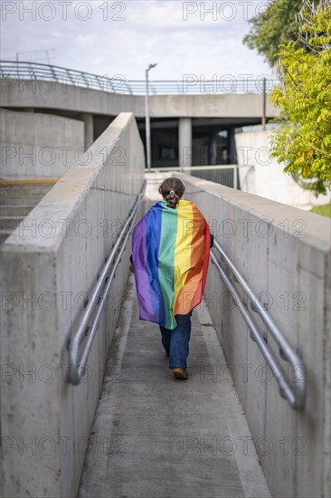 Woman from the back holding lgbt flag