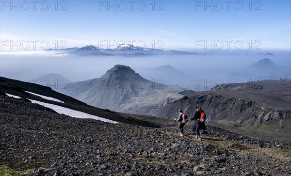 Two hikers on hiking trail through volcanic landscape
