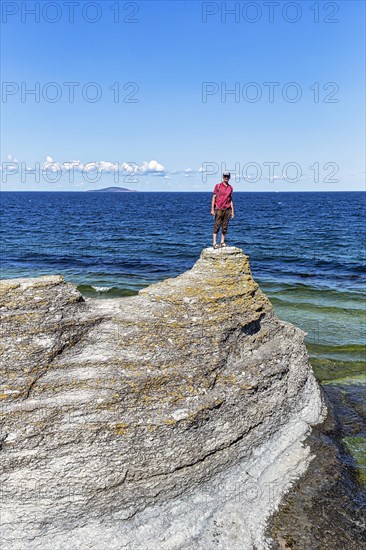 Hiker standing on limestone column