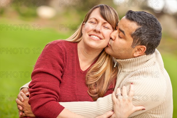 Attractive mixed-race couple portrait in the park