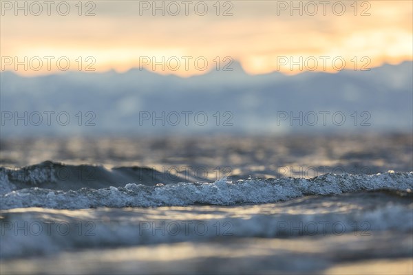 Sunrise on a wintry lake in bad weather