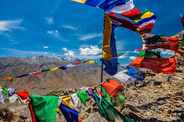 Buddhist prayer flags lungta with Om mani padme hum mantra written on them in Spiti Valley in Himalayas