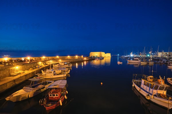 Venetian Fort Venetian fortress of Koules Castello a Mare castle in Heraklion and moored Greek fishing boats in port