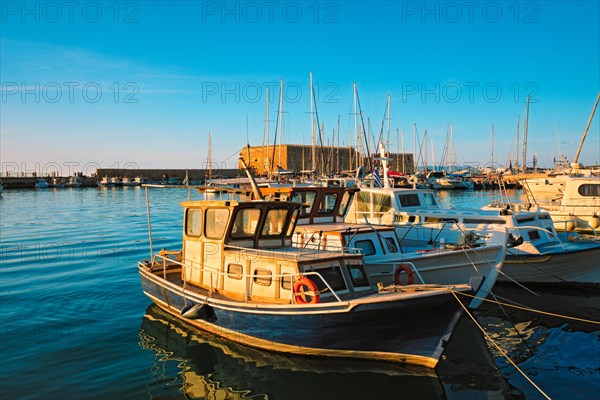 Venetian Fort Venetian fortress of Koules Castello a Mare castle in Heraklion and moored Greek fishing boats in port