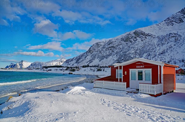 Red cottage in winter landscape