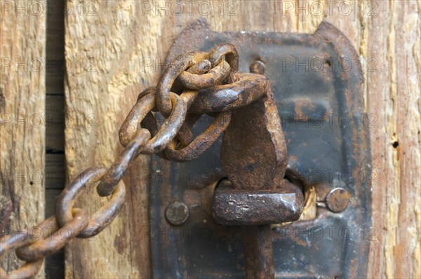 Antique rusty barn door latch and chain