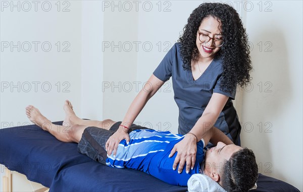 Female doctor with patient undergoing back treatment