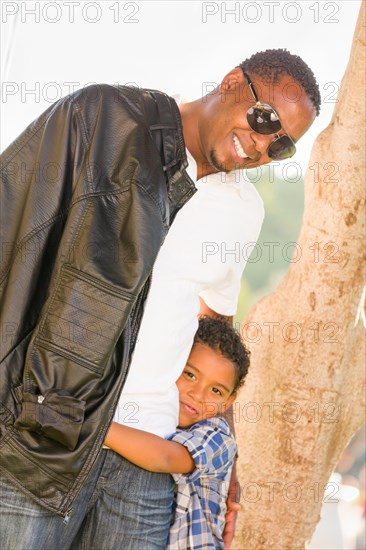 Happy african american father and mixed-race son playing at the park