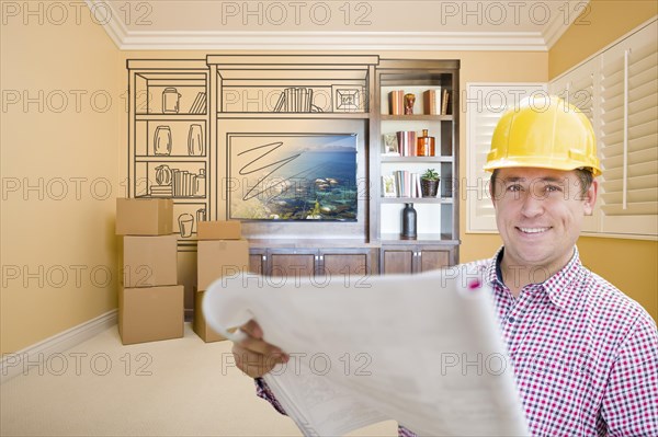 Male construction worker wearing hard hat in room with drawing of entertainment unit on wall