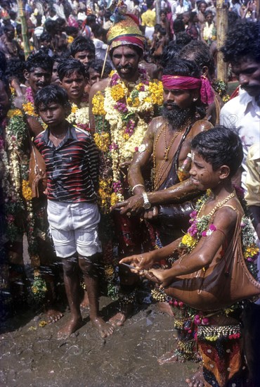 Devotees jetting water spray in Chitra or Chithirai festival