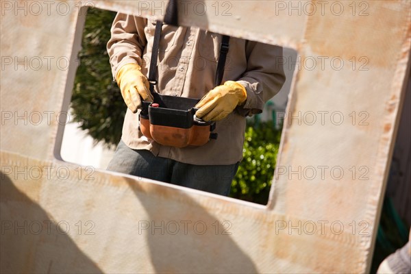 Utility worker with leather gloves using remote crane controller