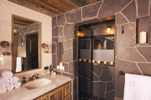 Luxurious rustic bathroom with mining lamps in spa setting