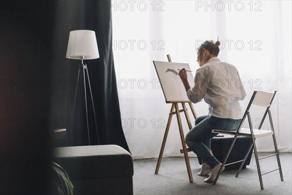 Artist painting in a room