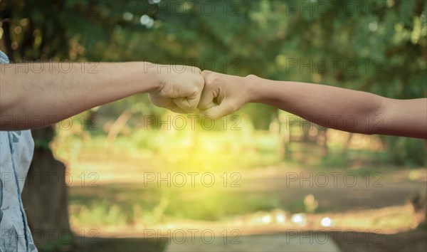 Two young men clashing their fists