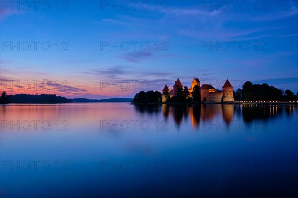 Night view of Trakai Island Castle in lake Galve illuminated in the evening