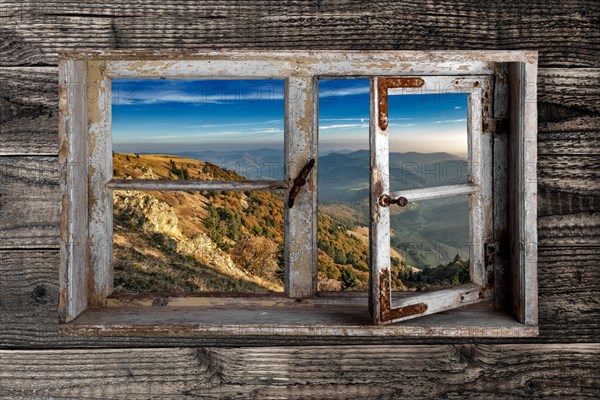 View through a rustic wooden window from the Belchen into the small Wiesental