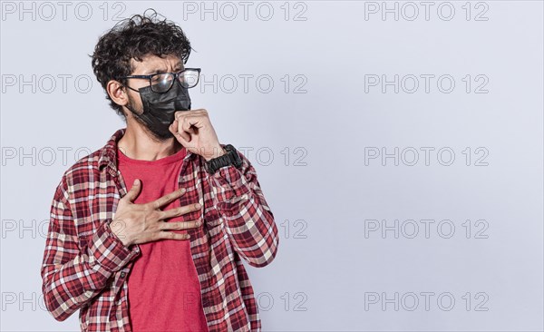 Man coughing with surgical mask