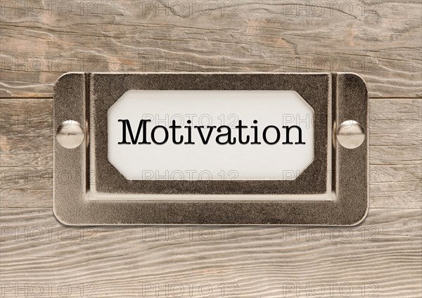 Motivation only metal file label frame on wood background