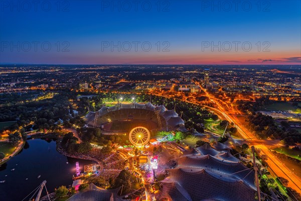 Munich from above at night with bright colours at sunset. View from the Olympic Tower during the Summer Festival