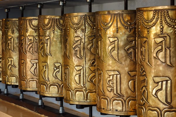 Metal buddhist prayer wheels in Tsuglagkhang complex in Dalai Lama residence