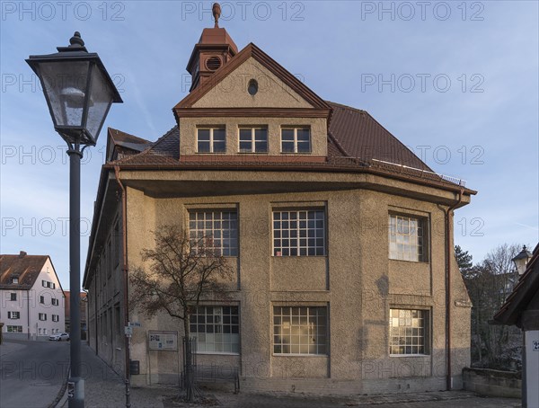 Historic main building of a former valve factory in the evening light