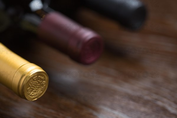 Various wine bottles on a reflective wood surface abstract