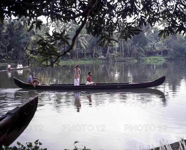 People being taken in a boat across the back waters of Alappuzha or Alleppey in Kerala