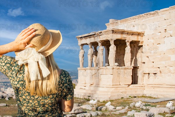 Woman gazes at the erechtheion or temple of athena polias