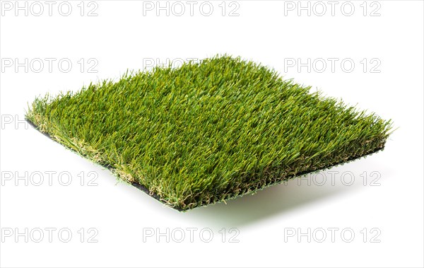 Section of artificial turf grass isolated on white background