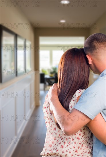 Curious military couple looking down the hallway of new house