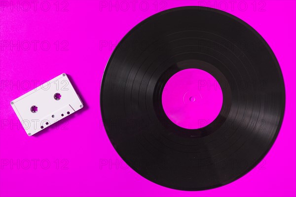 Audio white cassette tape vinyl record pink background