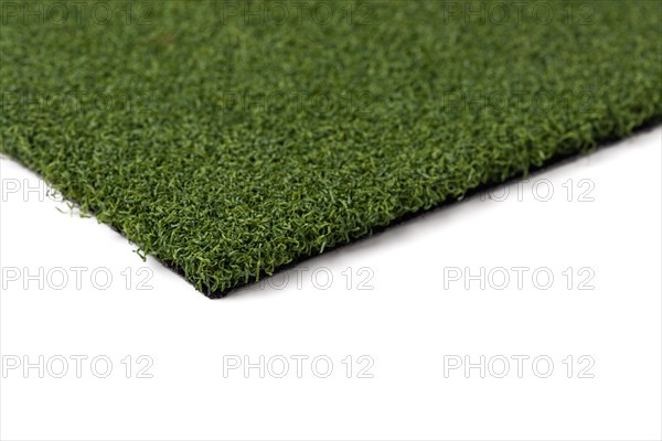 Section of artificial turf grass on white background