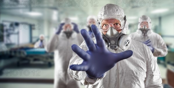 Team of female and male doctors or nurses wearing personal protective equipment in hospital emergency room