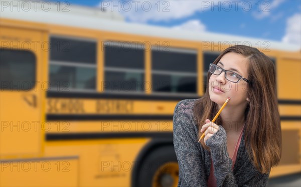 Young female student near school bus