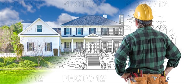 Male contractor with hard hat and tool belt looking at custom house drawing photo combination on white