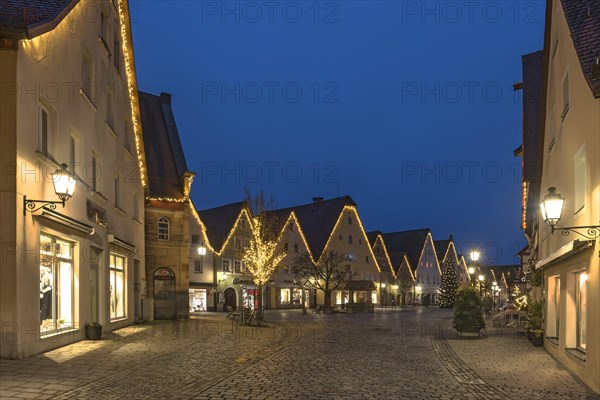 Christmas illuminated market place with old town hall and St. John's church in the evening
