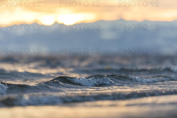 Sunrise on a wintry lake in bad weather